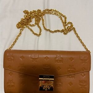MCM Cognac Embossed Leather Crossbody with Gold Chain in an excellent condition.
